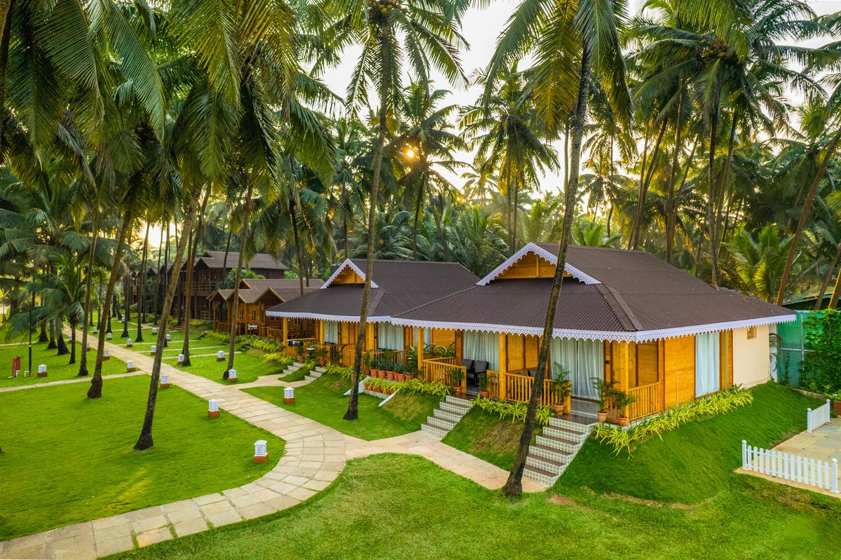 Resort wooden cottages among palm trees